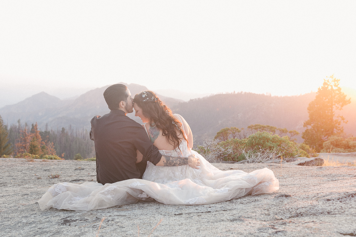 Couple sitting on granite at sunset with mountain views, Sequoia National Park